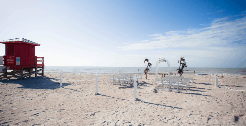 White Wedding Arch set up on Sand Key Beach