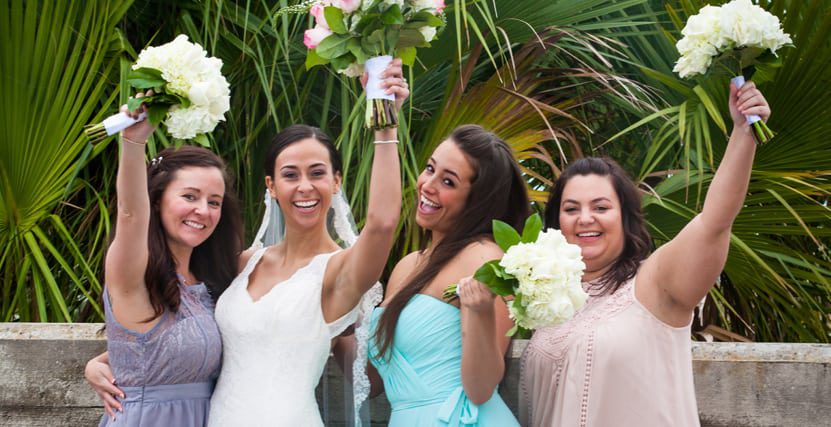 bridesmaids with bouquets in the air