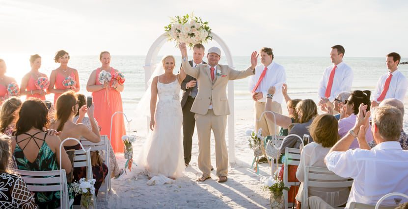 White Arch Ceremony on Sand Key Beach with Excited Couple